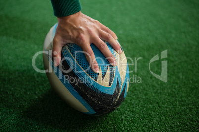 Cropped hand of person with rugby ball