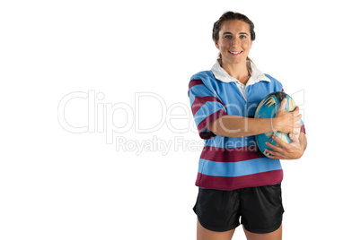 Portrait of happy female player holding rugby ball