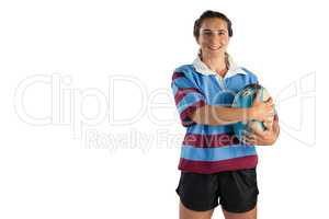 Portrait of happy female player holding rugby ball