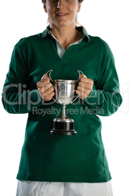 Mid section of smiling female rugby player holding trophy