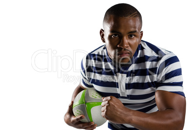 Close up portrait of young athlete with ball running while playing rugby