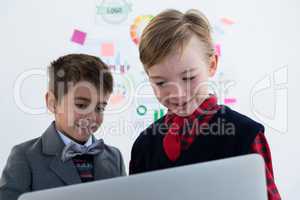 Kids as business executives using laptop