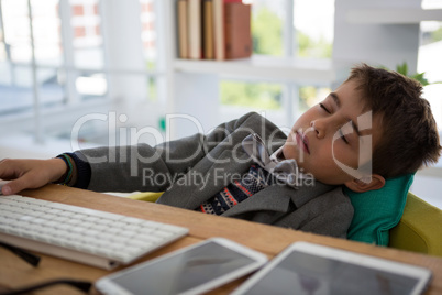 Boy as business executive sleeping