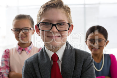 Kids as business executive smiling while standing in the office