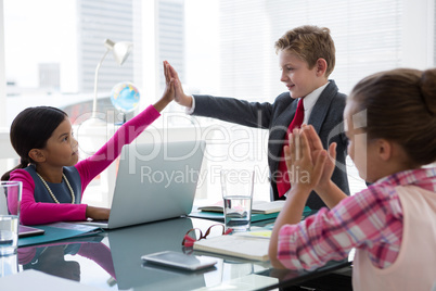 Kids as business executives interacting while meeting