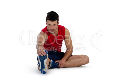 Full length of sports person stretching legs while exercising