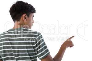 Teenage boy pressing an invisible virtual screen against white background