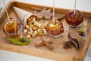 Popcorn, apple and apise on wooden tray