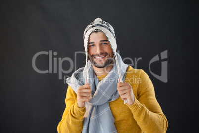 Portrait of smiling man holding wooly hat