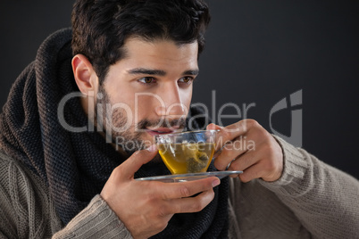 Thoughtful man having a cup of lemon tea