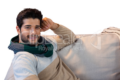 Portrait of smiling man relaxing on sofa