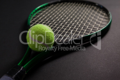 Close up of fluorescent yellow tennis racket and ball