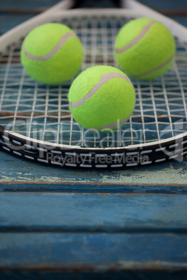 Close up of fluorescent yellow balls on tennis racket