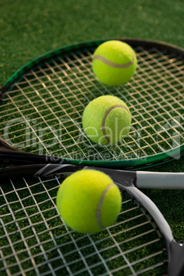 Close up of tennis balls on rackets