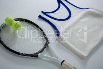 High angle view of racket with tennis balls by vest