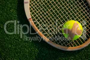 Overhead view of tennis ball with bandage on racket