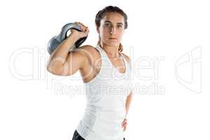 Portrait of female athlete holding kettlebell