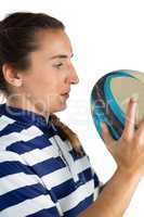 Side view of female athlete looking at rugby ball