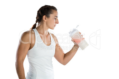 Female athlete looking at drinking bottle