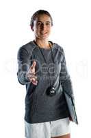 Portrait of female rugby coach extending arm for handshake