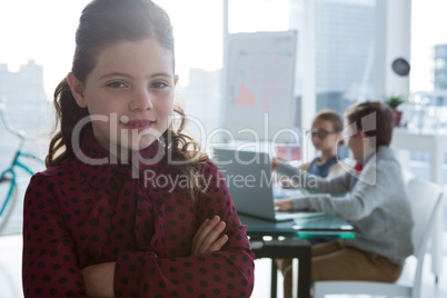 Girl as business executive smiling while standing in office