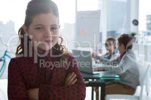Girl as business executive smiling while standing in office