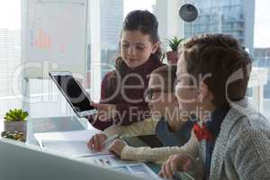 Kids as business executives discussion over digital tablet