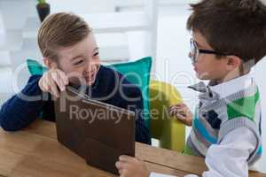 Kids as business executives interacting while using digital tablet