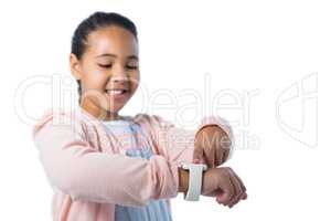 Smiling girl operating her smart watch