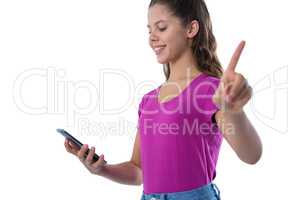 Teenage girl gesturing while using mobile phone