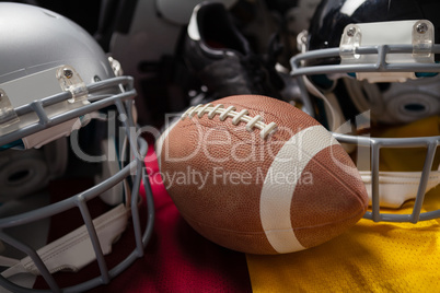 Close up of American football with helmets on jersey