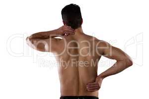 Rear view of shirtless sportsperson suffering from pain