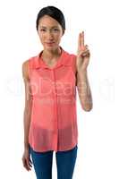 Smiling woman gesturing against white background