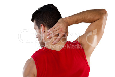 Rear view of American football player suffering from neck pain