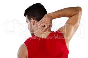 Rear view of American football player suffering from neck pain