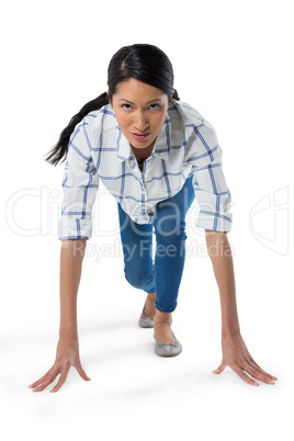 Woman getting ready to run against white background