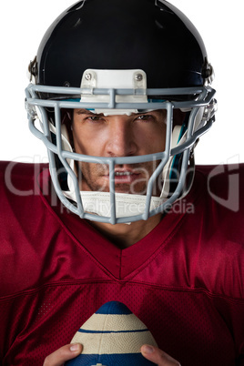 Portrait of determined American football player wearing helmet