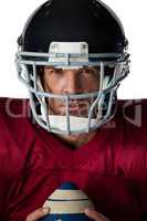 Portrait of determined American football player wearing helmet