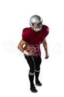 Full length of American football player wearing helmet