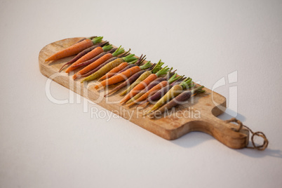 Carrots arranged on chopping board