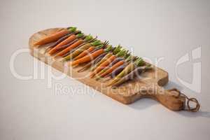 Carrots arranged on chopping board