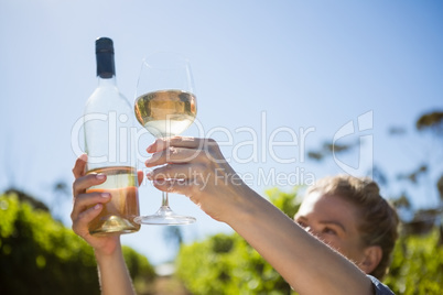 Female vintner examining wine