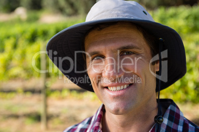 Handsome farmer smiling in field on a sunny day