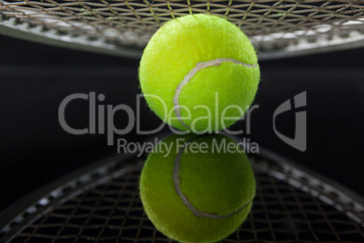 Close up of racket over tennis ball with reflection