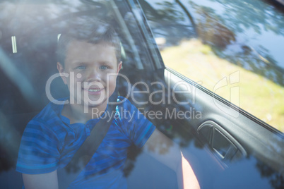 Teenage boy sitting in the front seat of car