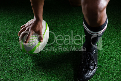 High angle view sportsman kicking rugby ball