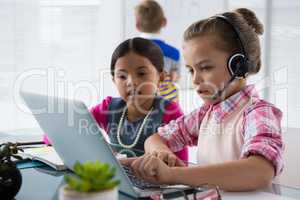 Kids as business executives working together in office