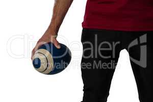 Cropped image of football player holding ball