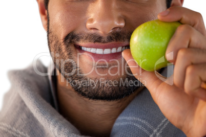 Close-up of smiling man holding apple