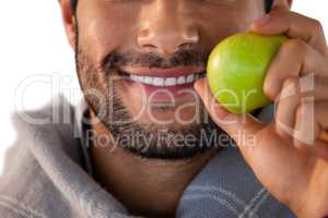 Close-up of smiling man holding apple